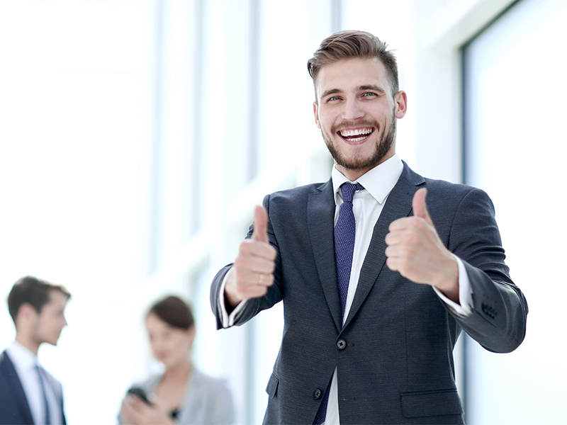 handsome businessman showing thumbs up